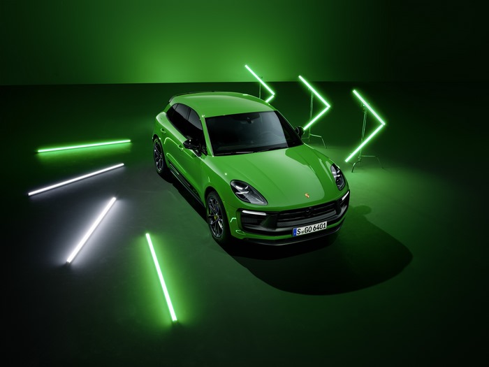 Green Porsche Macan GTS in a neon-lit studio