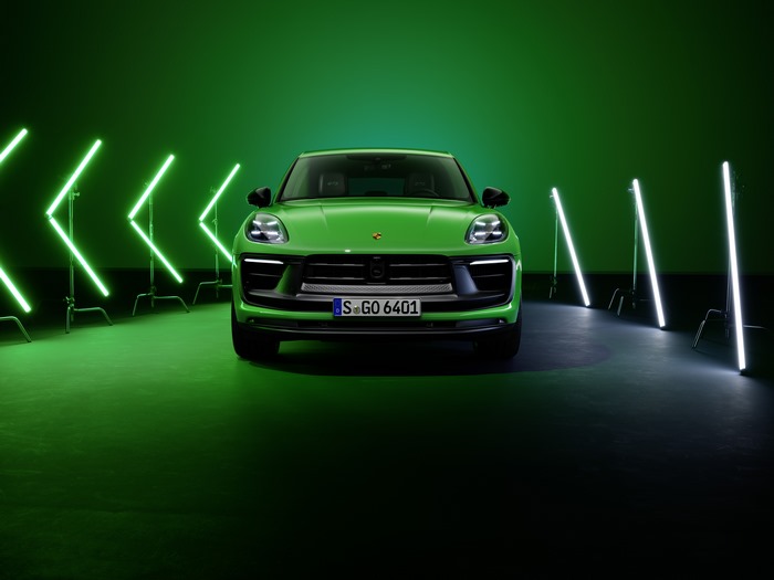 Green Porsche Macan GTS in vibrant studio lighting