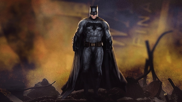 Batman standing in fiery destruction