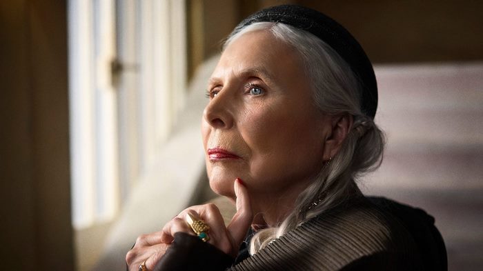 Joni Mitchell looking thoughtful in natural light