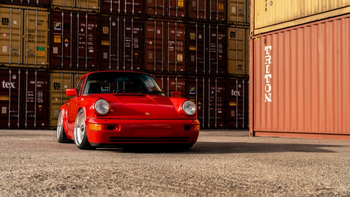 Red Porsche 964 Turbo in front of containers 4K