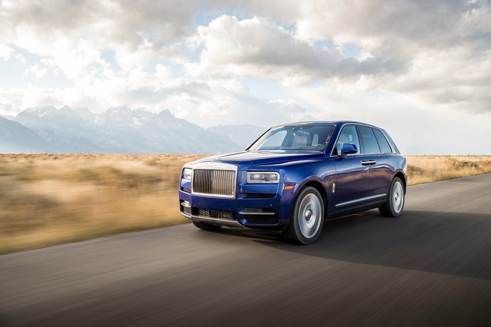 Rolls-Royce Cullinan SUV driving on a mountain road