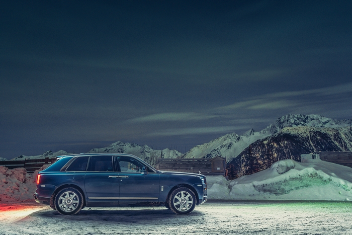 Rolls-Royce Cullinan SUV in snowy mountains at night 4K