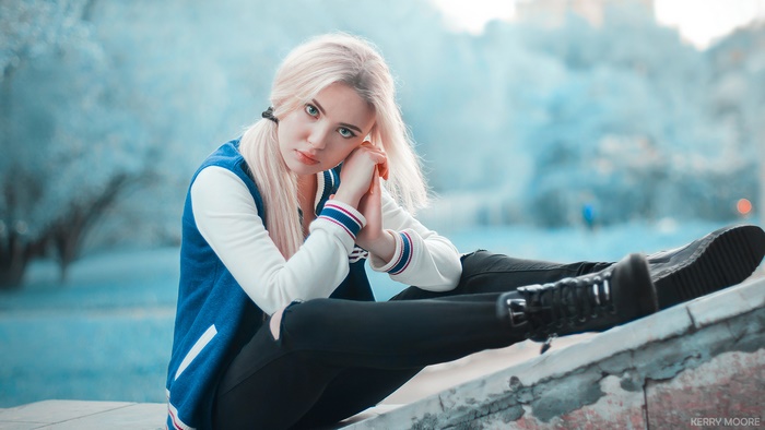Blonde Model Sitting Outdoors in Soft Light