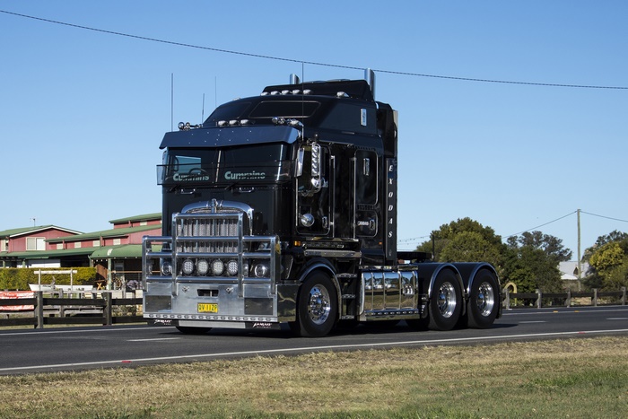 Shiny black Kenworth K200 truck on road