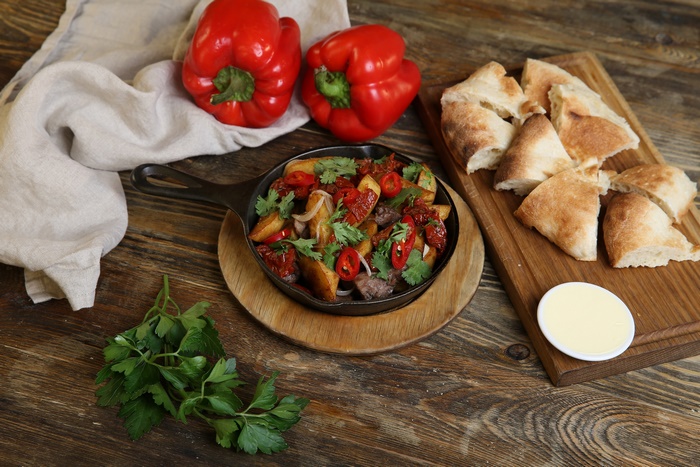Rustic skillet meal with bread and red peppers