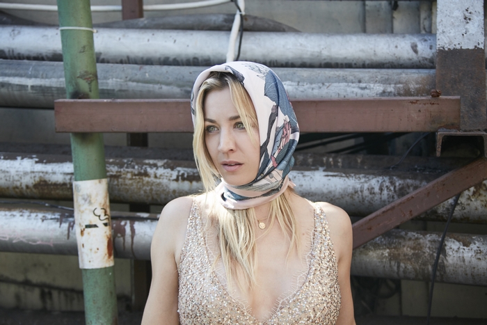 Kaley Cuoco in a headscarf and sparkly top
