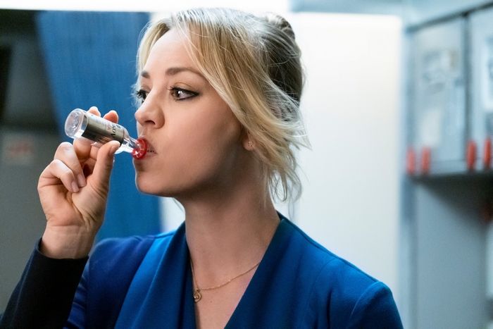 Kaley Cuoco drinking from a bottle in The Flight Attendant