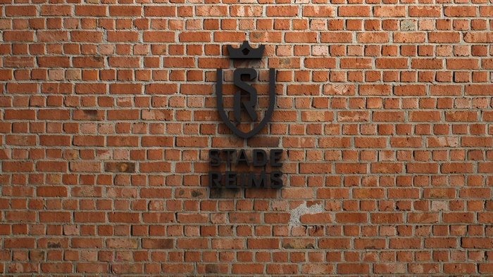 Stade de Reims logo emblem on brick wall