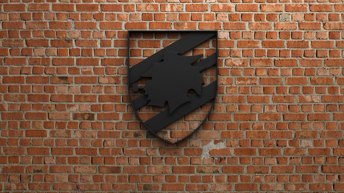 Black U.C. Sampdoria logo emblem on brick wall