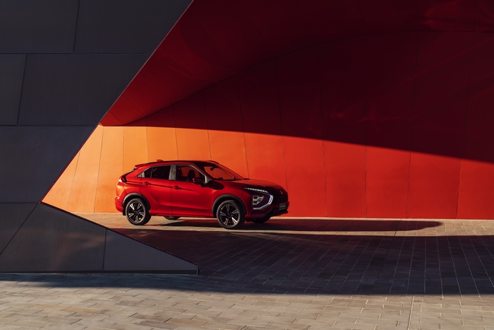 Red Mitsubishi Eclipse Cross SUV in striking architectural setting