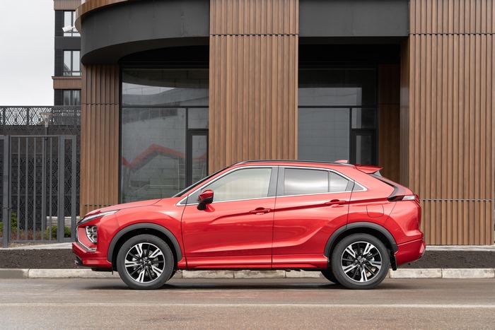 Red Mitsubishi Eclipse Cross SUV parked by modern building