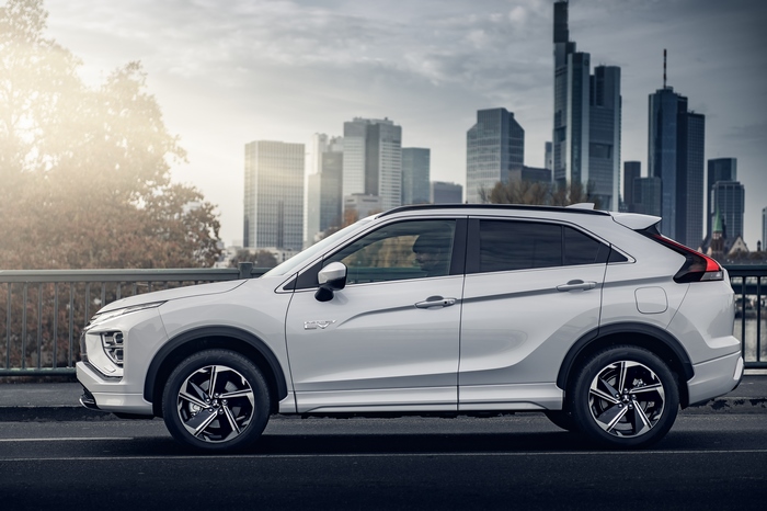 White Mitsubishi Eclipse Cross SUV against city backdrop