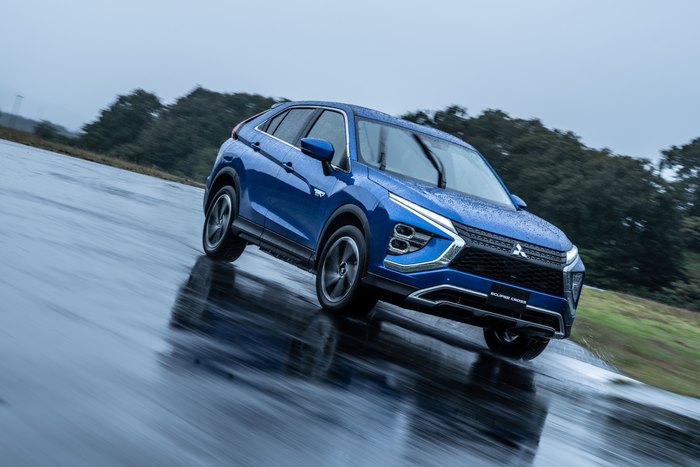 Blue Mitsubishi Eclipse Cross SUV on wet road