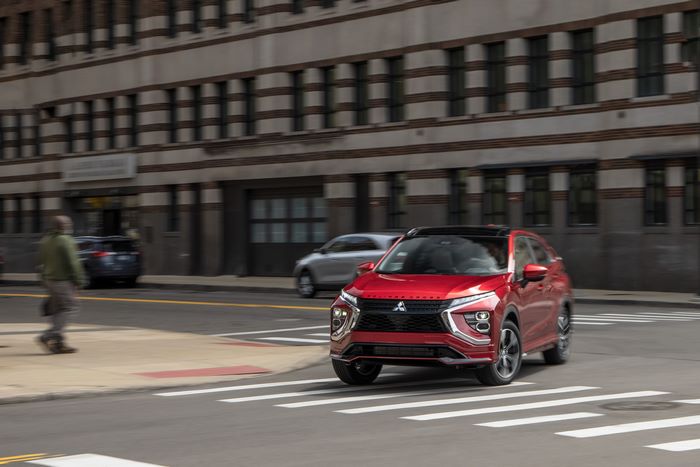 Red Mitsubishi Eclipse Cross SUV driving in city