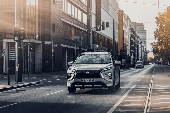 Mitsubishi Eclipse Cross SUV driving on a sunny city street