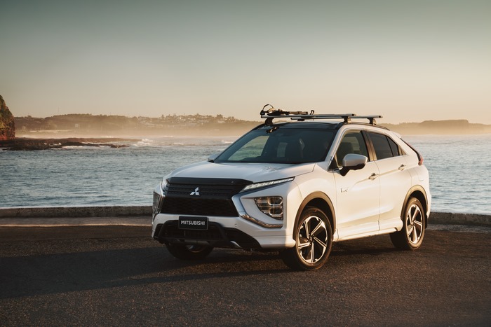 White Mitsubishi Eclipse Cross PHEV SUV by the ocean