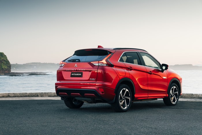 Red Mitsubishi Eclipse Cross PHEV SUV by the ocean