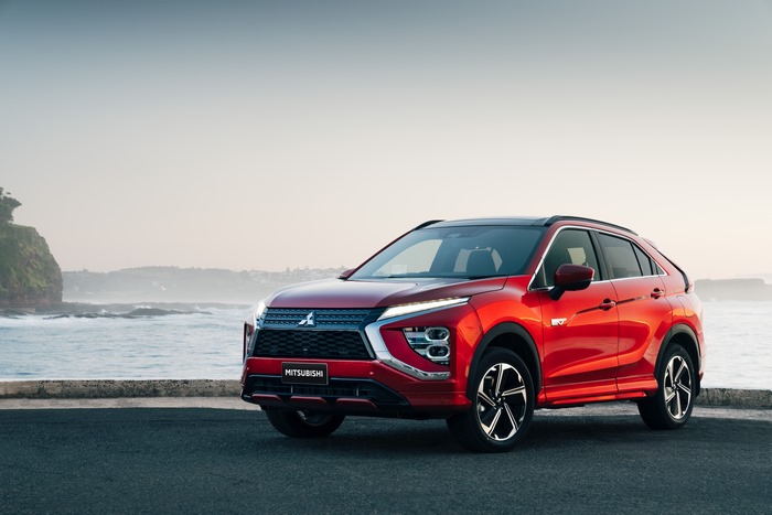 Red 2021 Mitsubishi Eclipse Cross PHEV SUV by the ocean