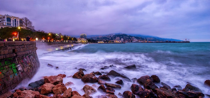Yalta Embankment: Misty Sea and City Lights at Dusk