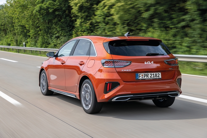 Orange Kia Ceed GT-Line driving on a highway
