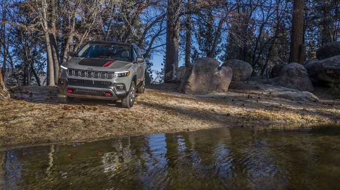 Jeep Compass Trailhawk SUV on a trail by the water.