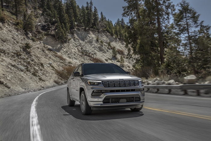 Silver Jeep Compass High Altitude SUV on a winding mountain road.