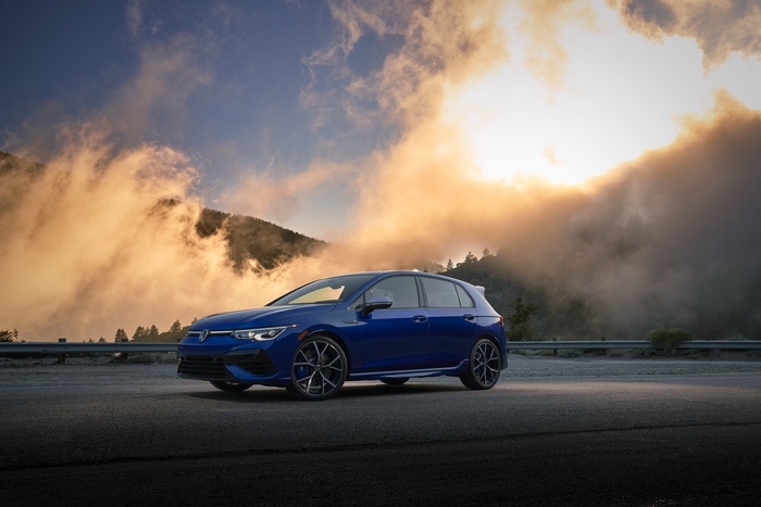 Blue Volkswagen Golf R on a dramatic mountain road