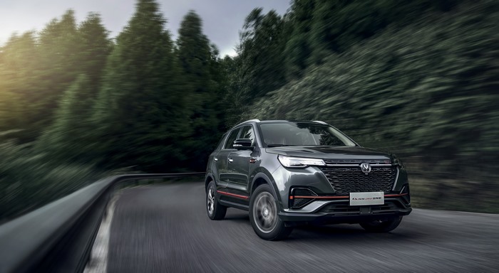 Changan CS55 Plus SUV driving on a winding forest road