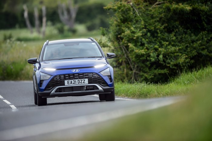 Blue 2021 Hyundai Bayon SUV driving on a country road