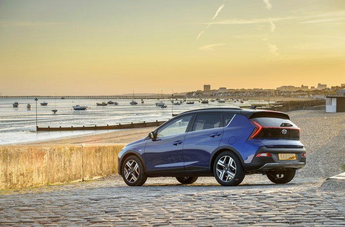 Blue 2021 Hyundai Bayon SUV by the sea at sunset