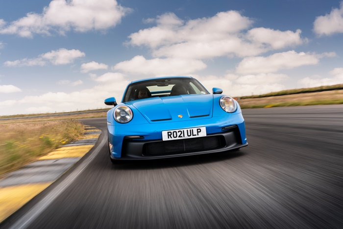 Blue 2021 Porsche 911 GT3 on a race track