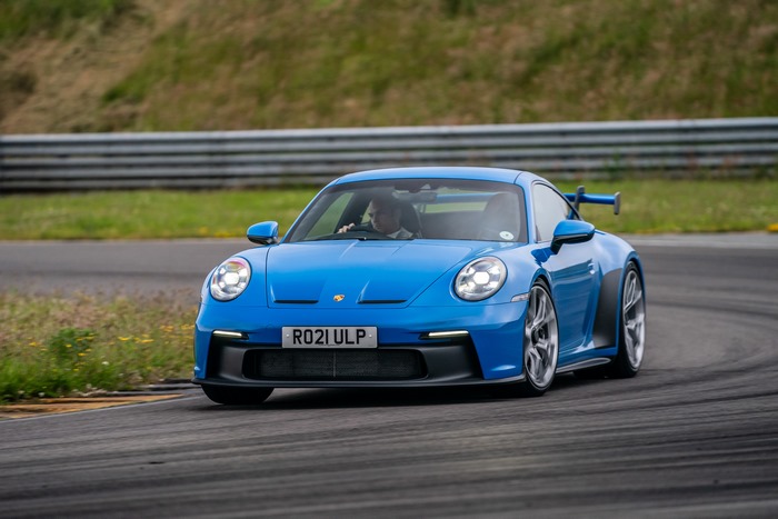 Blue 2021 Porsche 911 GT3 on a race track