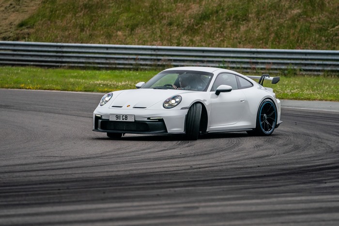 White Porsche 911 GT3 PDK on a race track
