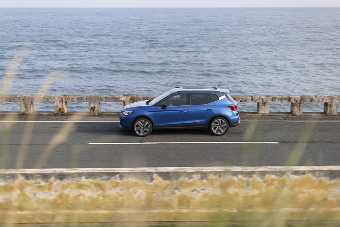 Blue 2021 SEAT Arona FR driving by the ocean