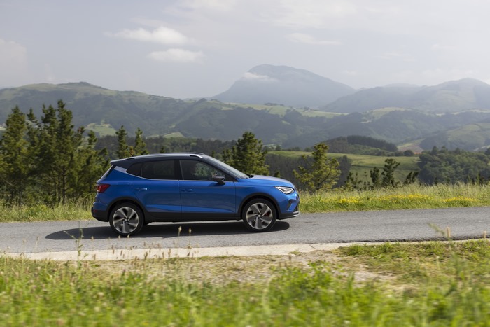Blue 2021 SEAT Arona FR SUV driving on scenic road