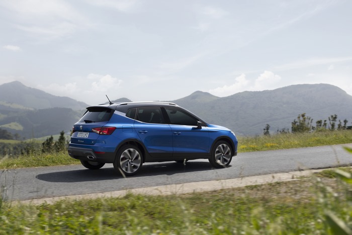 Blue 2021 SEAT Arona FR SUV driving on a road