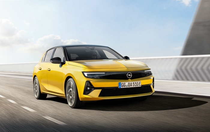 Yellow 2021 Opel Astra Hybrid driving on a highway
