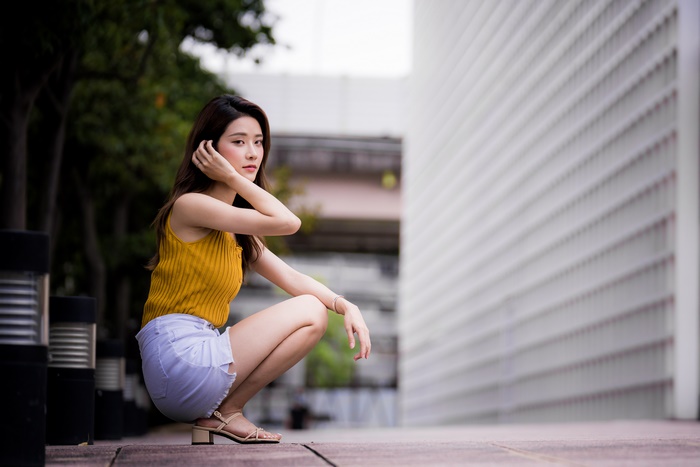 Asian model in yellow top and denim shorts