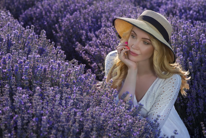 Blonde woman in hat in lavender field