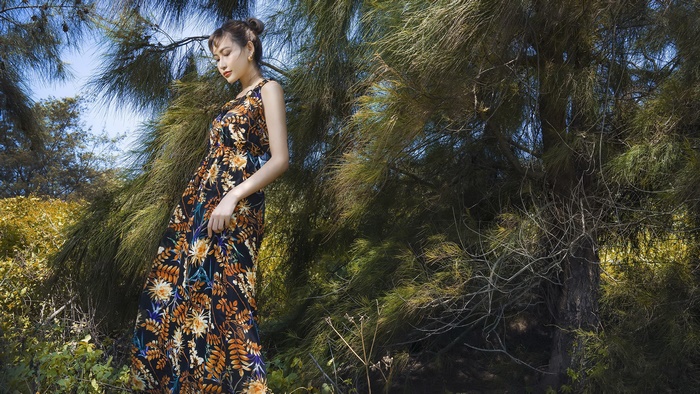 Asian model in a floral dress in a natural setting