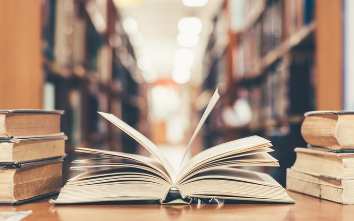Open book in library with depth of field