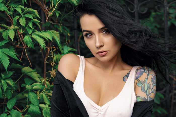 Model with brown eyes, black hair, and a tattoo