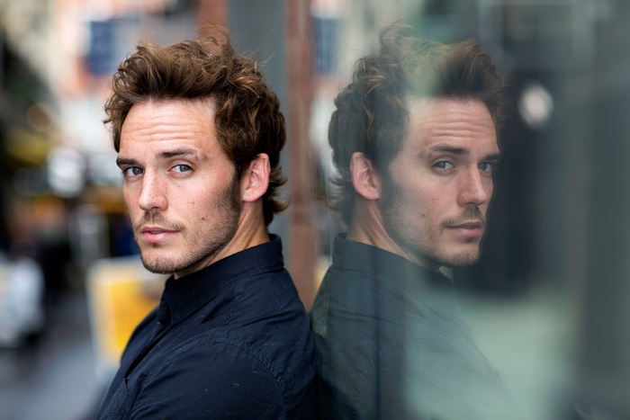 Sam Claflin's reflection in a window
