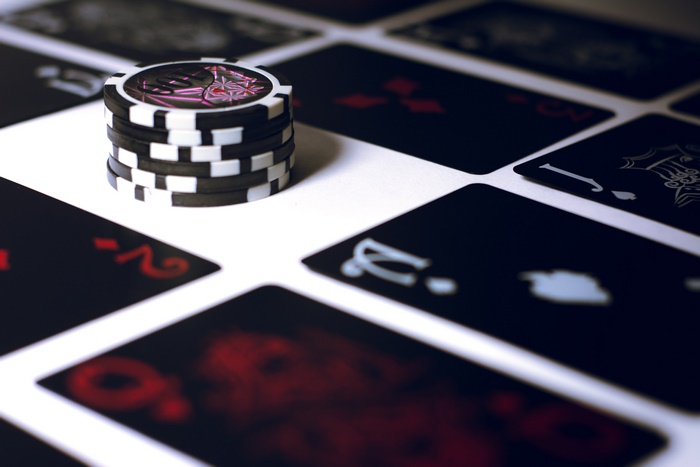 Poker chips and cards on a white surface