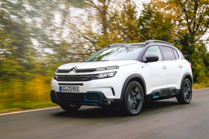 White Citroën C5 Aircross SUV Hybrid driving on a road