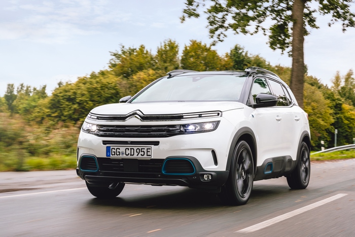 White Citroën C5 Aircross SUV Hybrid driving on a road