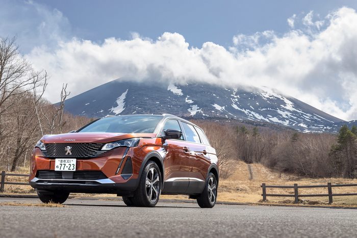 Orange Peugeot 5008 GT SUV with Mount Fuji in background