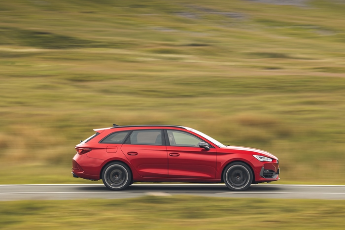 Red Cupra Leon Estate driving on a road