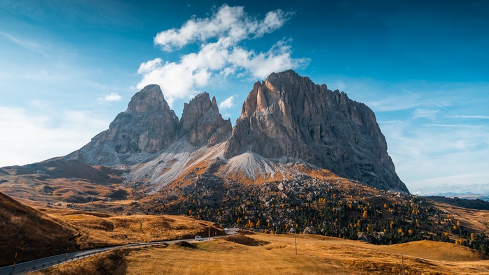 Dolomites mountain range under a blue sky with clouds